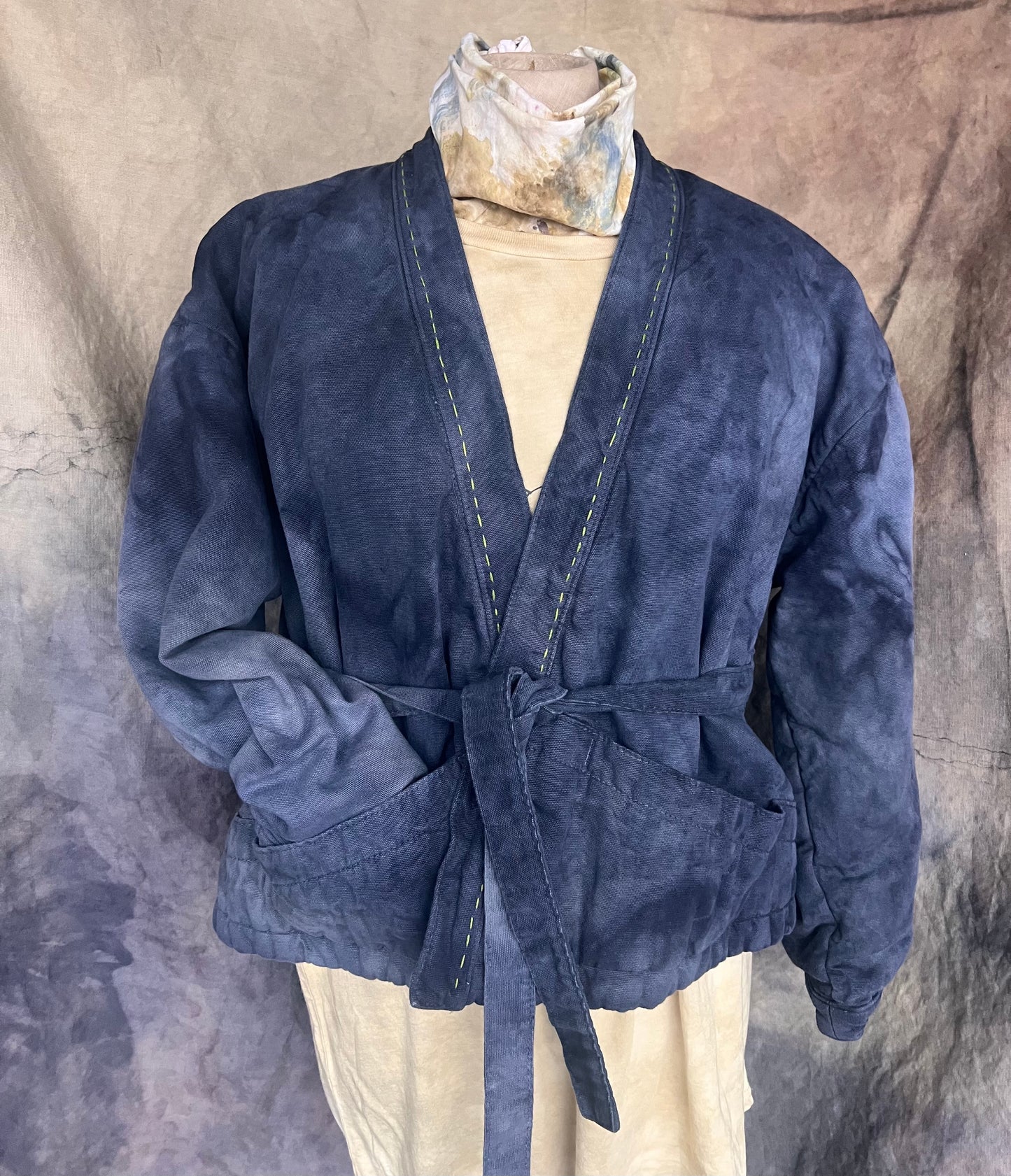Blue indigo dyed short coat with waist tie styled on a mannequin