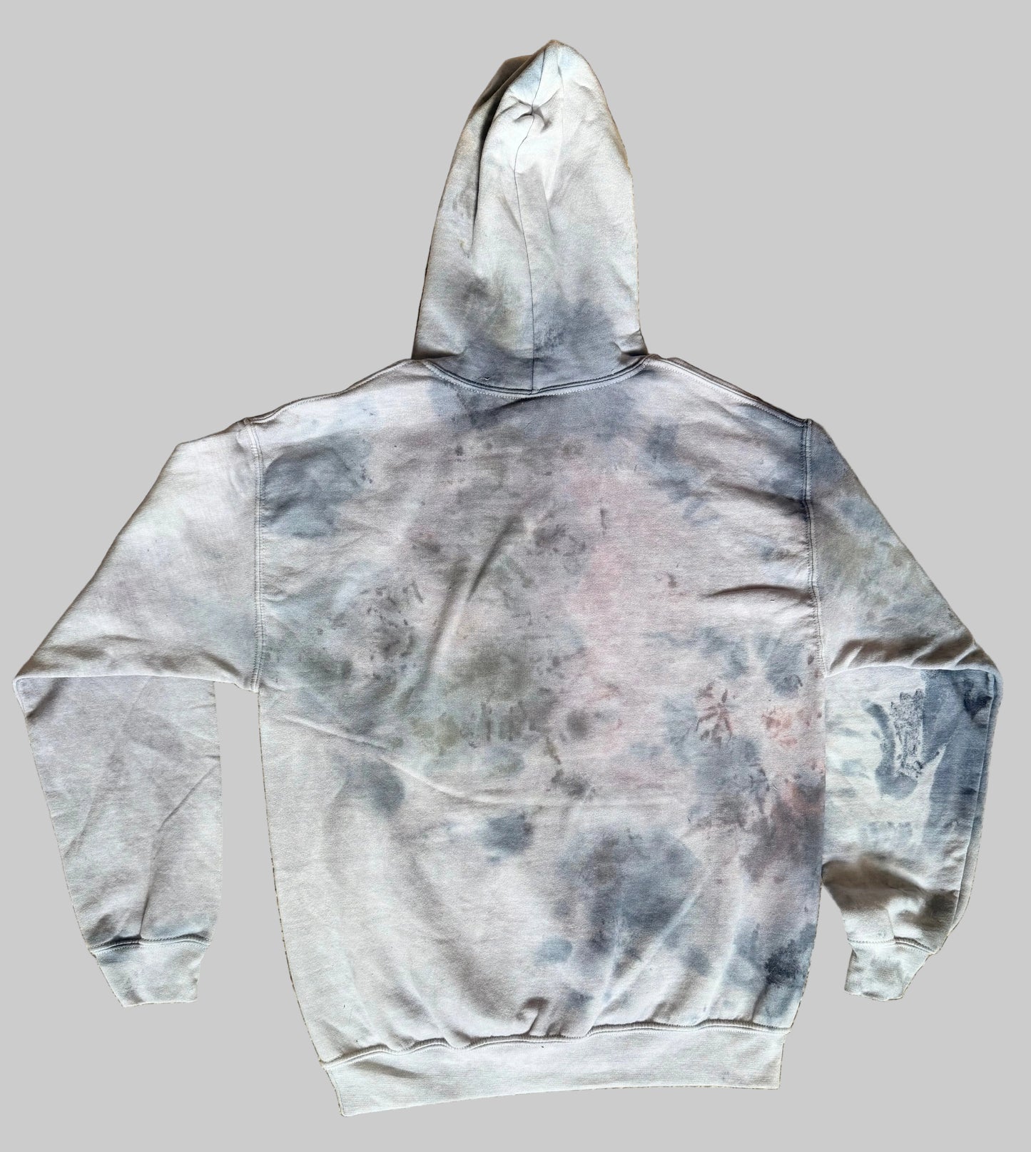 Gray tie-dye hoodie on a textured brown surface