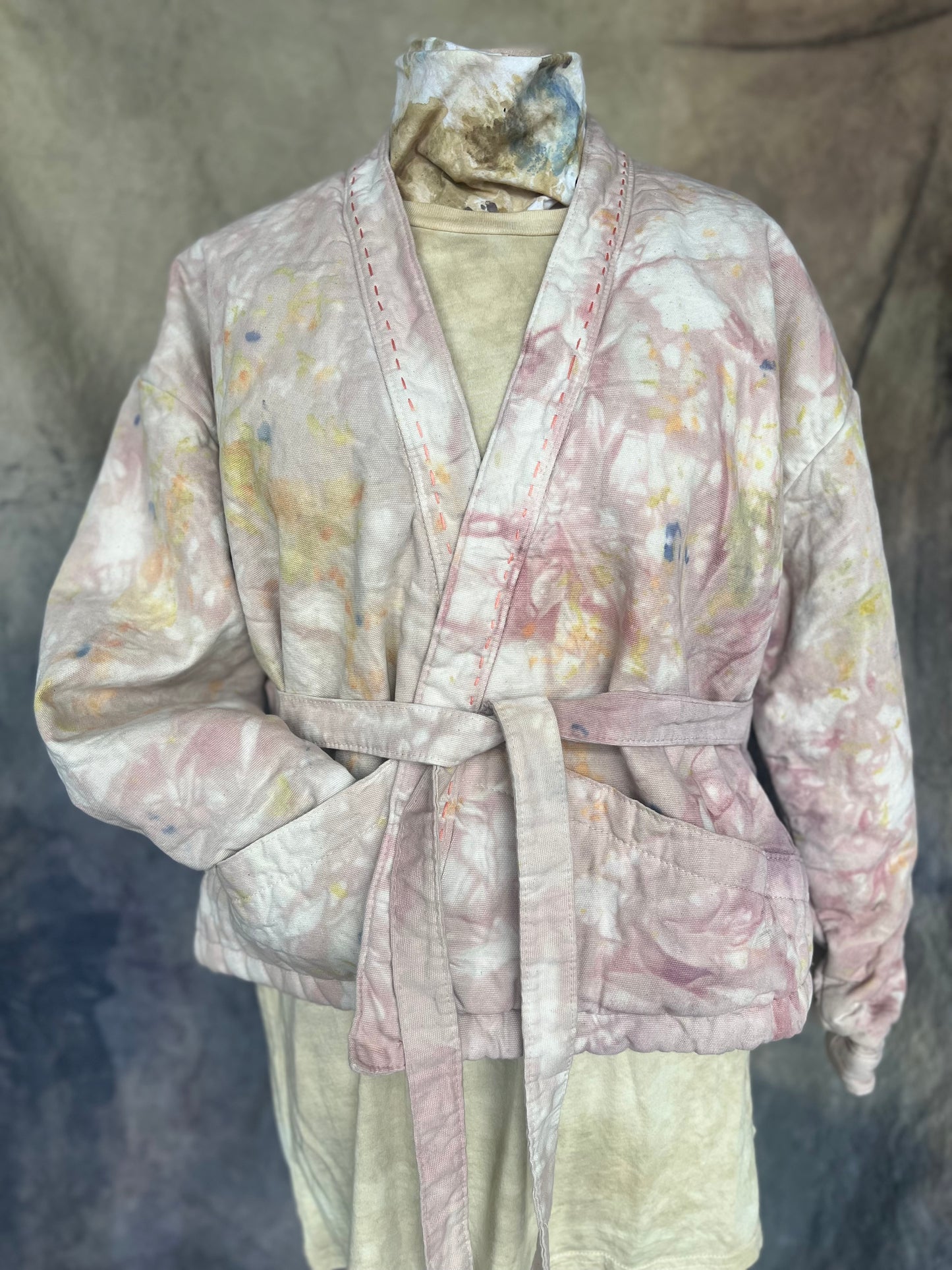 Floral patterned short  wrap coat with tie at waist styled on a mannequin.