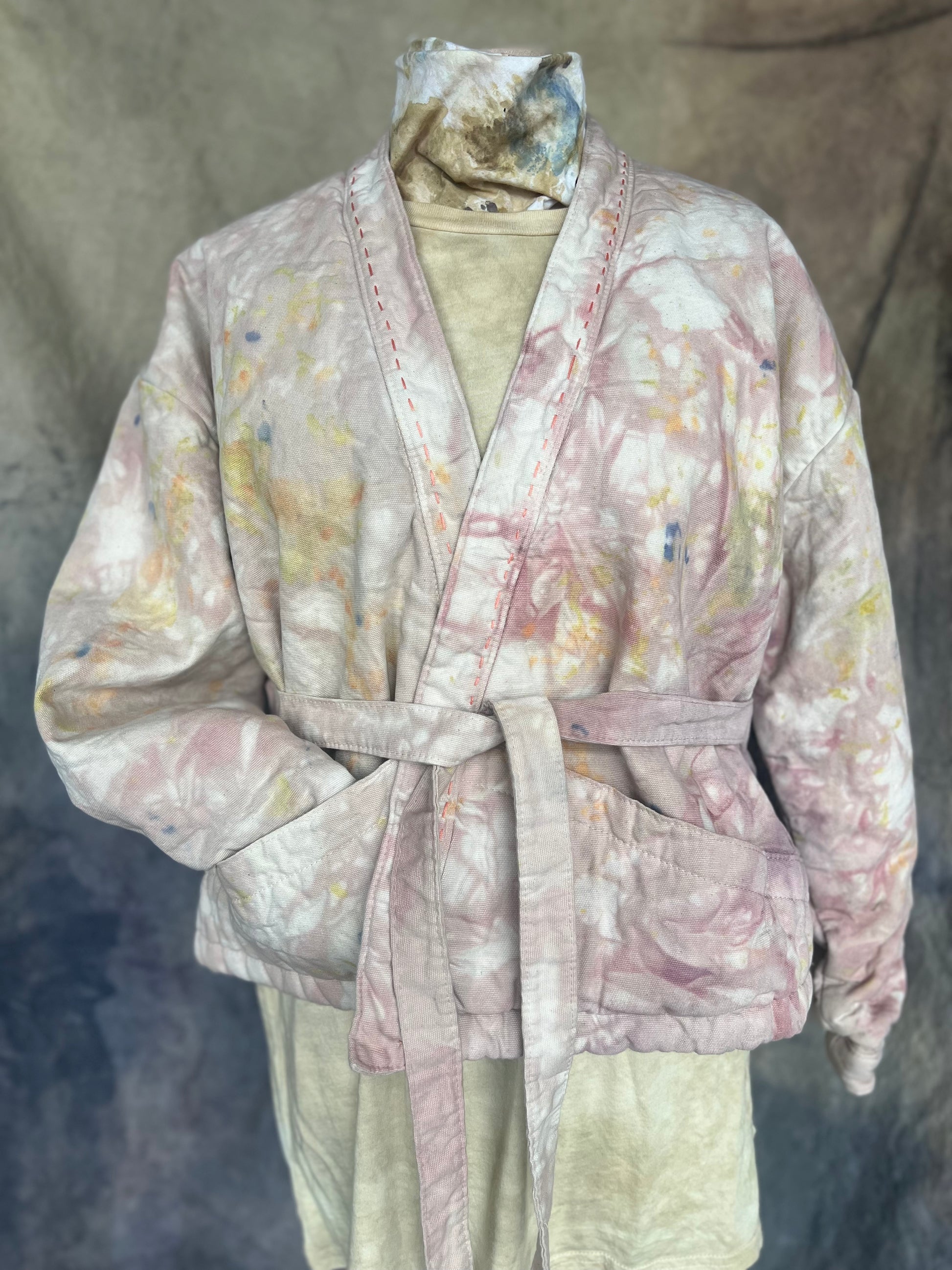 Floral patterned short  wrap coat with tie at waist styled on a mannequin.