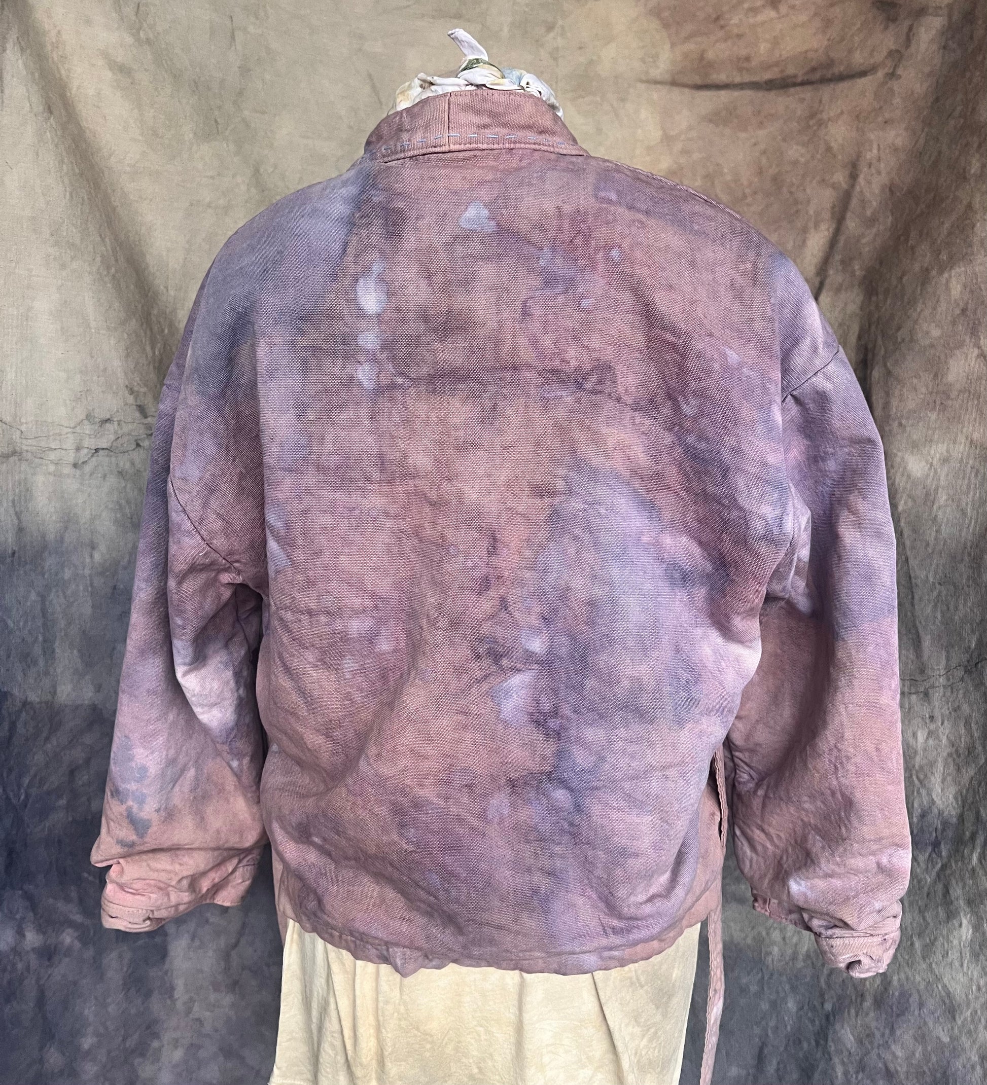 back view of short wrap coat dyed with flowers for a mauve and blue indigo abstract pattern.