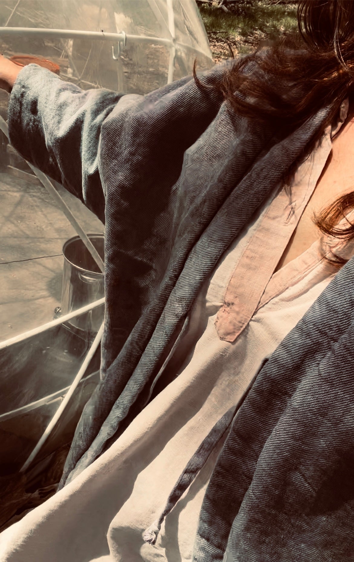 girl wearing kimono style blanket coat in garden dome